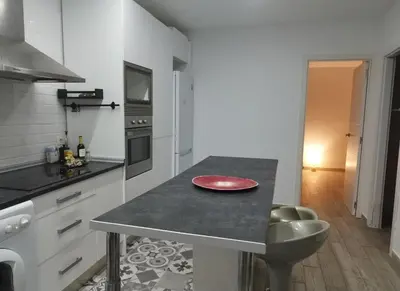 a kitchen with a table with a red plate on it at Encanto de Valencia in Cuart de Poblet