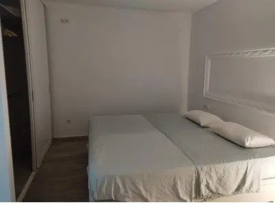 a bedroom with a bed with two pillows on it at Encanto de Valencia in Cuart de Poblet
