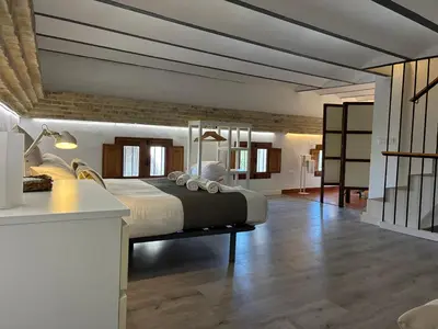 a bedroom with a large bed and a desk at Trenor Apartments in Valencia
