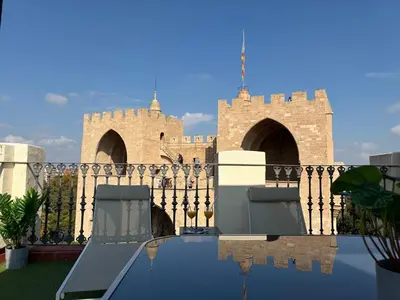 a castle with two chairs in front of a pool at Trenor Apartments in Valencia