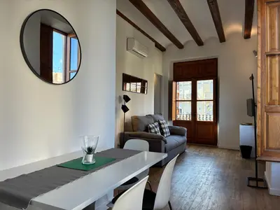 a living room with a table and a couch at Trenor Apartments in Valencia