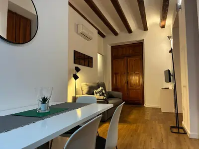 a living room with a table and chairs and a couch at Trenor Apartments in Valencia