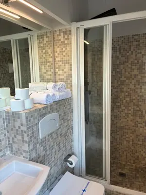 a bathroom with a toilet and a sink and a shower at Trenor Apartments in Valencia