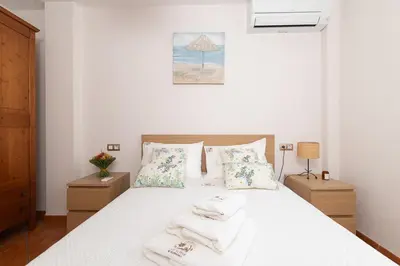a bedroom with a white bed with towels on it at Your Paradise with Pool - 2 min from Beach in Moncófar