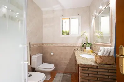 a bathroom with a toilet and a sink at Your Paradise with Pool - 2 min from Beach in Moncófar
