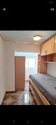 a bedroom with a bed and a door in it at Habitación con dos camas para dos personas in Valencia