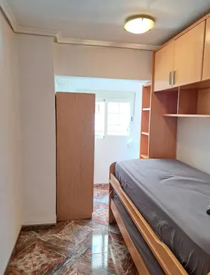 a bedroom with a bed and a door to a room at Habitación con dos camas para dos personas in Valencia
