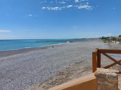 a view of a beach with a wooden fence at Blanca Mar in Barrio-Mar