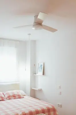 a bedroom with a bed and a ceiling fan at Blanca Mar in Barrio-Mar