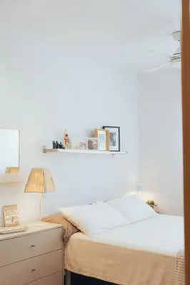 a bedroom with a bed and a desk with a lamp at Blanca Mar in Barrio-Mar
