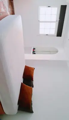 a white room with brown pillows on the floor at Habitación cómoda in Valencia