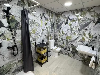 a bathroom with a shower and a toilet and a sink at El Jardín de Darío in Valencia