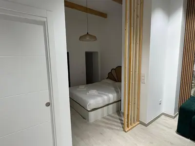 a small bedroom with a bed and a mirror at El Jardín de Darío in Valencia