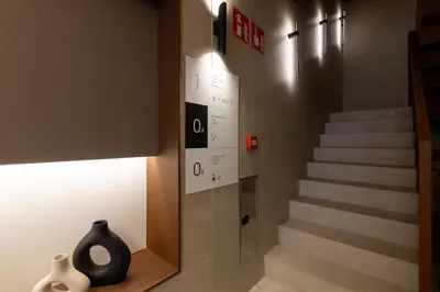 a staircase with a black vase sitting on a shelf at Moontels Colón in Valencia
