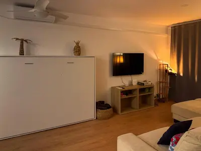 a living room with a large white cabinet and a tv at Apartmento en 5 Mares in Puebla de Farnals