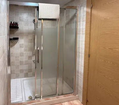 a shower with a glass door in a bathroom at Apartmento en 5 Mares in Puebla de Farnals