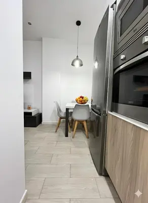a kitchen with a table and a refrigerator at Casa moderna en Manises con 2 terrazas in Manises
