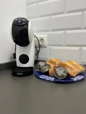 a coffee maker sitting next to a plate of food at Casa moderna en Manises con 2 terrazas in Manises