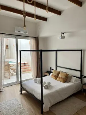 a bedroom with a bed in a room with a patio at Apartamento acogedor frente a Plaza de la Iglesia in Valencia