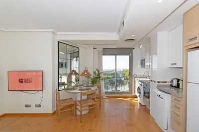 a kitchen with a table and a dining room at GuestReady – Modern Flat with Terrace in Valencia in Valencia