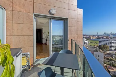 a balcony with a table and a view of a city at GuestReady – Modern Flat with Terrace in Valencia in Valencia