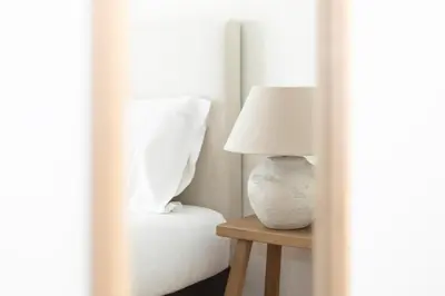 a lamp sitting on a table next to a bed at GuestReady – Modern Flat with Terrace in Valencia in Valencia
