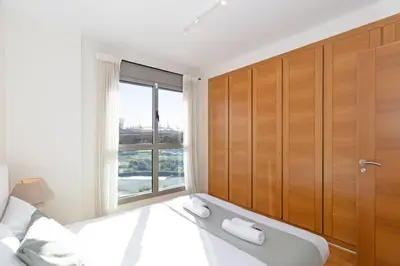 a bedroom with a bed and a large window at GuestReady – Modern Flat with Terrace in Valencia in Valencia