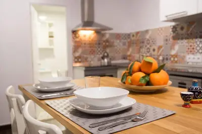 a kitchen with a table with bowls of oranges on it at Window to Central Market in Valencia