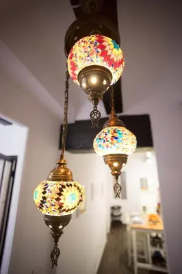 a group of three lights hanging from a ceiling at Window to Central Market in Valencia