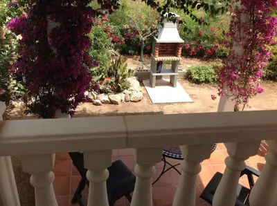 a view from the balcony of a garden with flowers at Casita Ramona in Valencia