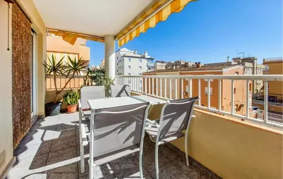 a balcony with a table and chairs on a balcony at Stunning Apartment In Moncofa With Swimming Pool in Moncófar