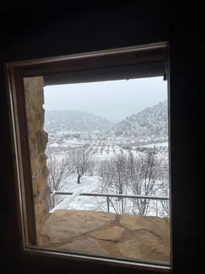 a window with a view of a snow covered field at La Ontina Alojamientos Rurales in Abejuela
