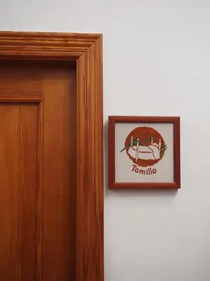 a picture of a sign on a wall next to a door at La Ontina Alojamientos Rurales in Abejuela