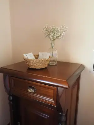 a table with a vase of flowers and a basket on it at La Ontina Alojamientos Rurales in Abejuela