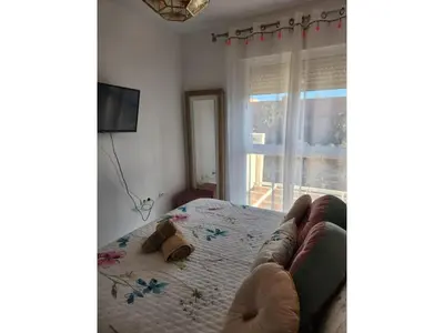 a living room with a couch and a window at Apartment in Vera with rooftop pool in Valencia