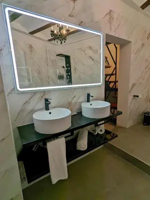 a bathroom with two sinks and a large mirror at Hotel Catalina Suites in Valencia