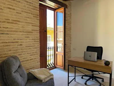 a room with a desk and a chair and a laptop at Apartamentos Valencia Centro 1 in Valencia