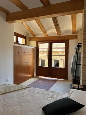 a bedroom with a bed and a wooden door at Apartamentos Valencia Centro 1 in Valencia
