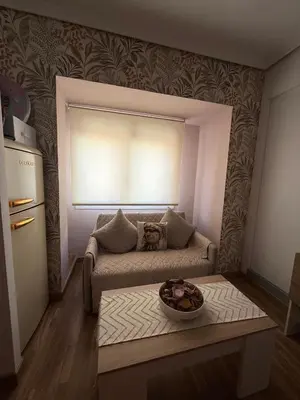 a living room with a couch and a window at Duplex Ático con terraza y BBQ in Puerto de Sagunto
