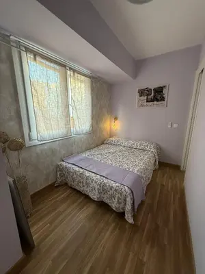 a bedroom with a bed and a large window at Duplex Ático con terraza y BBQ in Puerto de Sagunto