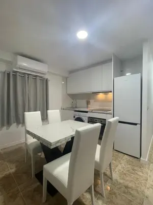 a kitchen with a table and chairs and a refrigerator at Valentia Rooms - Baleares in Valencia
