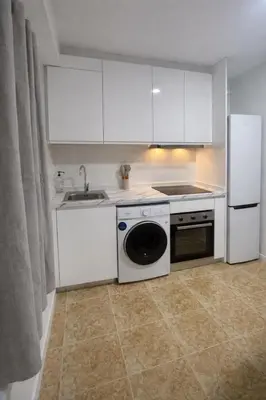 a kitchen with a sink and a washing machine at Valentia Rooms - Baleares in Valencia