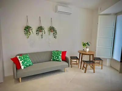 a living room with a couch and a table at Glamour Suite 2 next to the city center in Valencia