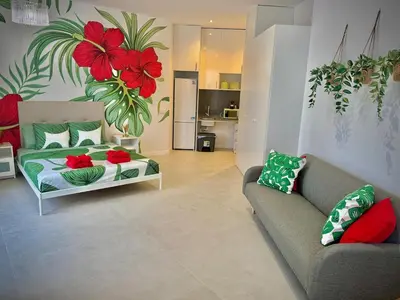 a living room with a bed and a couch at Glamour Suite 2 next to the city center in Valencia