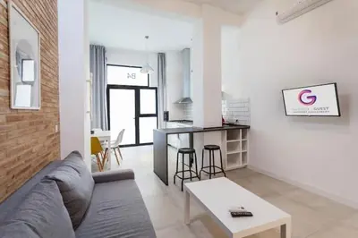 a living room with a couch and a table at New Flat center historic Ruzafa Wifi AC in Valencia