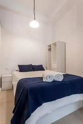 a bedroom with a bed with two towels on it at New Flat center historic Ruzafa Wifi AC in Valencia