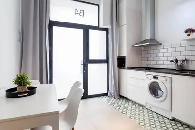a white kitchen with a washing machine in it at New Flat center historic Ruzafa Wifi AC in Valencia