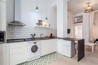 a white kitchen with a washing machine in it at New Flat center historic Ruzafa Wifi AC in Valencia