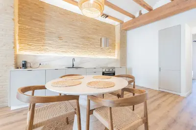 a kitchen with a table and chairs in a room at Yturralde by Alma Suites in Valencia
