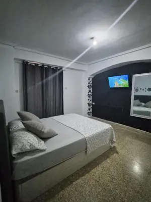 a bedroom with a bed and a tv on the wall at democracia delux in Valencia